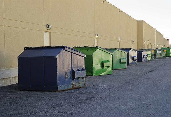 a yellow construction dumpster filled with waste materials in Highland Park